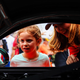 Straus showing a young girl her race car. Photo credit: Wes Duenkel, used with permission